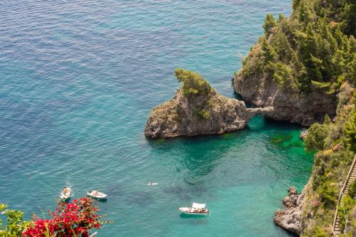 a cove with boats in the water next to a mountain at Villa Lauro Old Chapel in Amalfi