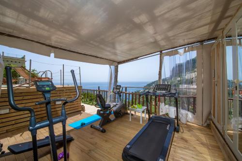 a gym with a balcony with a view of the ocean at Villa Lauro Old Chapel in Amalfi