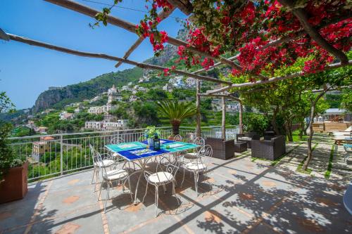 a table and chairs on a patio with a view at Villa Lauro Old Chapel in Amalfi