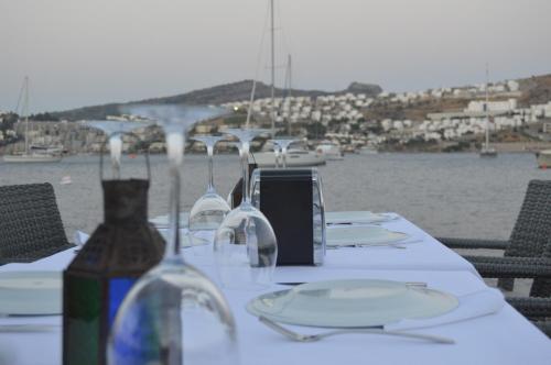 a table with glasses and a bottle of wine at Marisol Boutique Hotel in Gundogan