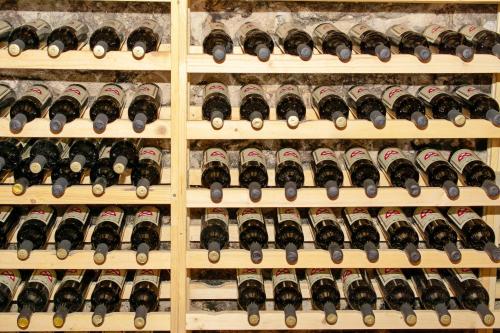 a bunch of bottles of wine on a shelf at Rooms Sveti Toma in Virpazar