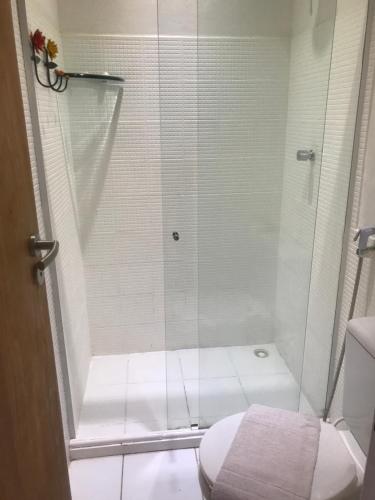 a small bathroom with a shower with a toilet at Pousada Bar Café Algas Marinhas in Praia do Forte