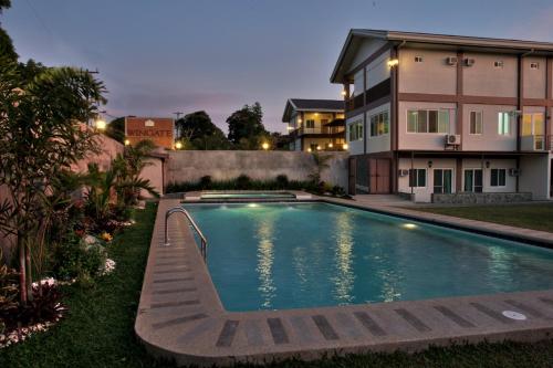 a swimming pool in front of a house at Tagaytay Wingate Manor in Tagaytay