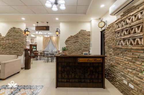 a lobby with a large brick wall and a counter at Casa Marita Vigan in Vigan