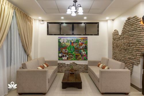 a living room with two chairs and a table at Casa Marita Vigan in Vigan