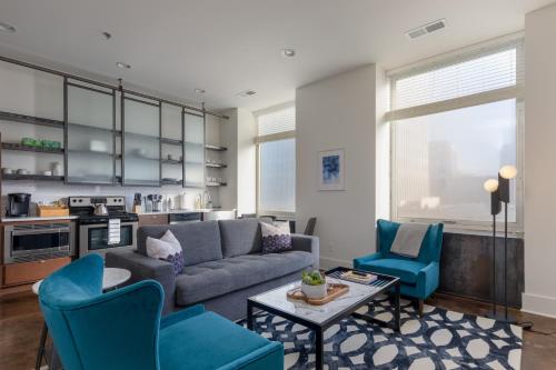 a living room with a couch and two chairs at The Nashville Reserve, by Oliver in Nashville