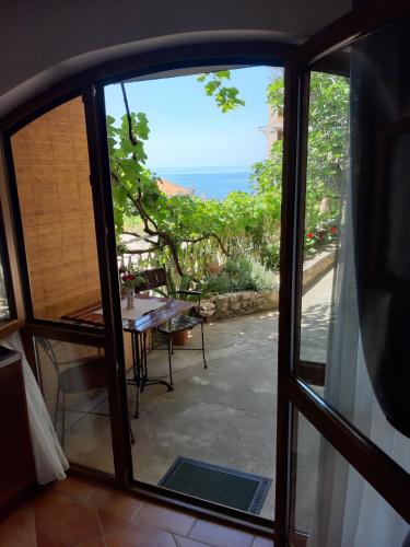 a view of the ocean from a window at Zoro Apartments in Sveti Stefan