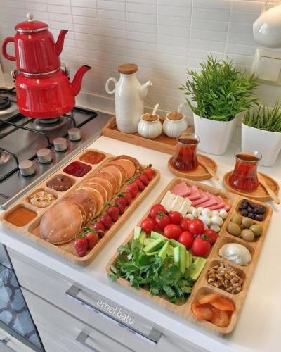 a table with two trays of food on a stove at istanbul Airport Kumsal Otel in Arnavutköy