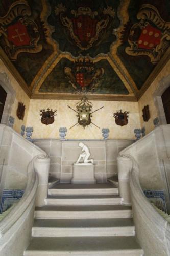 a staircase in a building with a statue on the ceiling at Parador Casa Da Insua in Penalva do Castelo