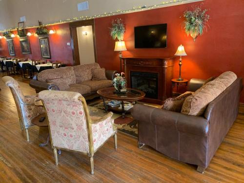 a living room with couches and a fire place at Hotel Garza in Post