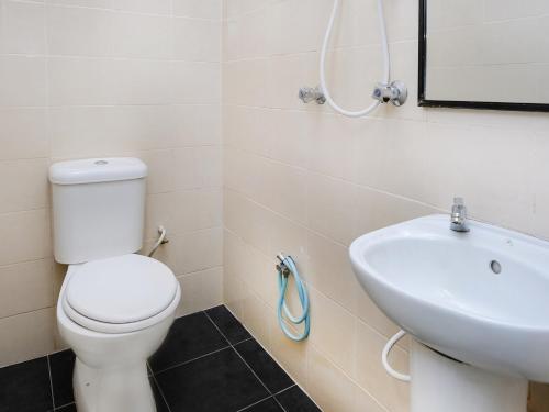 a bathroom with a toilet and a sink at Ridel Boutique Hotel in Wakaf Che Yeh