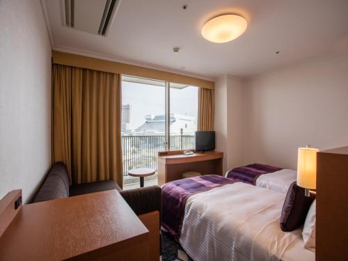 Ένα ή περισσότερα κρεβάτια σε δωμάτιο στο Ryogoku View Hotel