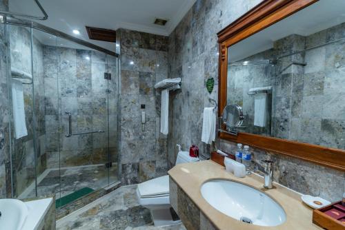 a bathroom with a sink and a shower at Empress Residence Resort and Spa in Siem Reap