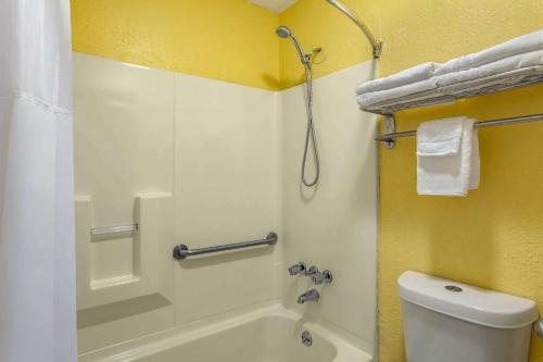 a bathroom with a shower and a tub and a toilet at Days Inn by Wyndham Greensboro Airport in Greensboro
