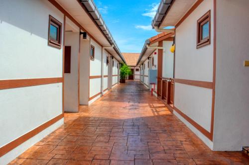 an alleyway between two buildings with a blue sky at AlexaPD Private Water Chalets in Port Dickson