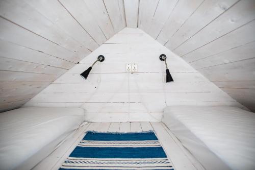 a small room with two beds and two lights at Westergårds in Föglö