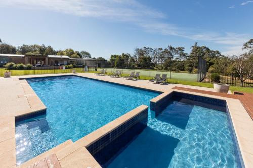 a large swimming pool with blue water at Ramada Resort by Wyndham Phillip Island in Cowes