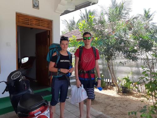 a man and a woman standing in front of a house at Juda Holiday Villa in Batticaloa
