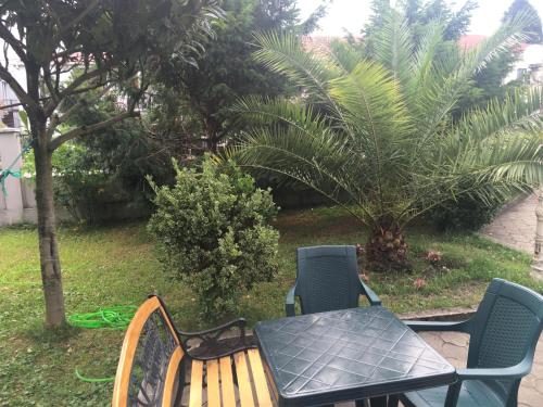 a wooden table and chairs and a table and a table and a table and chairs at ALEX'S HOUSE in K'obulet'i
