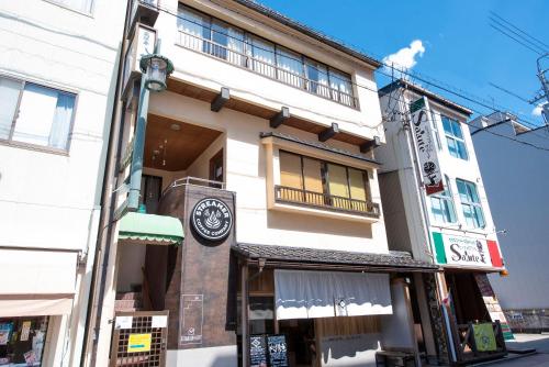 a building with a clock on the side of it at BEYOND HOTEL Takayama 2nd in Takayama