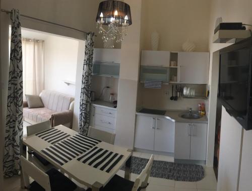 a kitchen and living room with a table and a dining room at Apartments in Bar city center in Bar