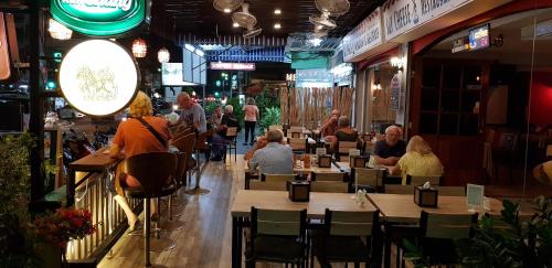 a group of people sitting at tables in a restaurant at Restaurant & Guesthouse Say Cheese in Hua Hin