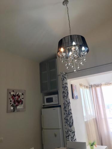 a chandelier hanging from a ceiling in a kitchen at Apartments in Bar city center in Bar