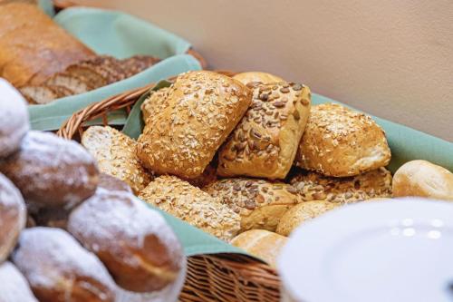 a basket full of different types of donuts and pastries at Hotel Gromada Łomża in Łomża