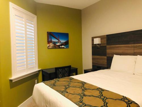 a bedroom with a large bed and a window at Bay Hotel in San Francisco