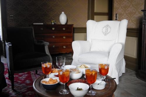 a coffee table with food and drinks on it with a chair at Château de Villemorien in Villemorien