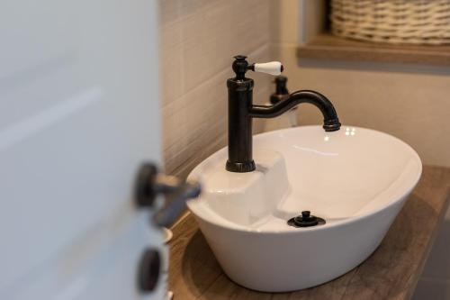 a bathroom sink with a faucet on a counter at Relax Village Home Mare in Krk