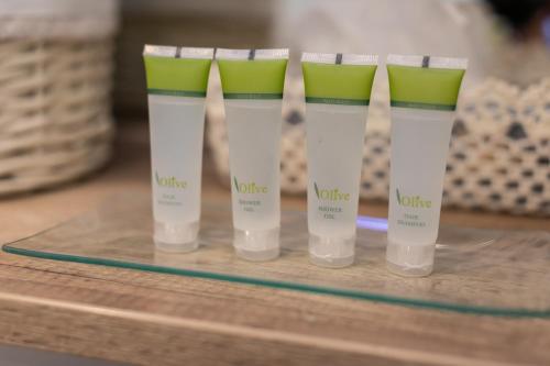 a group of four bottles of moisturizers on a table at Relax Village Home Mare in Krk