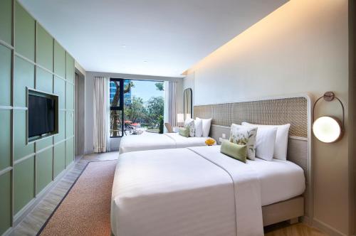 A bed or beds in a room at Amari Pattaya