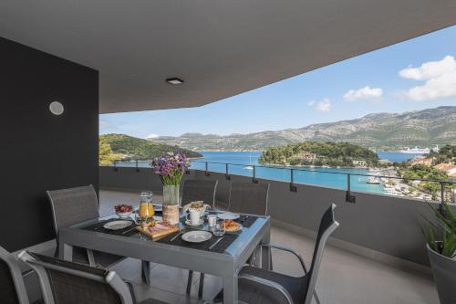 a dining room with a table and a view of the water at Korcula Hill in Korčula