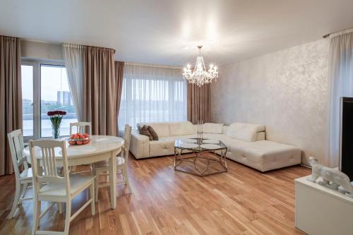 a living room with a couch and a table at Pallasti Luxury Apartment in Tallinn
