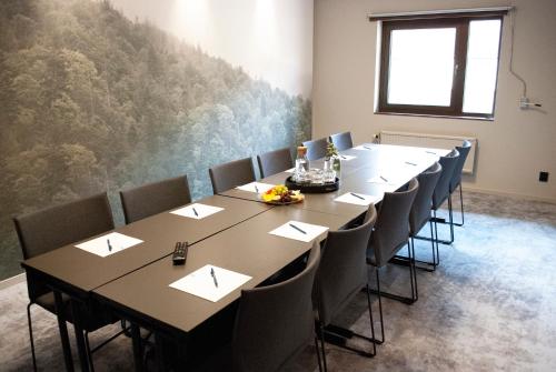 a conference room with a long table and chairs at Best Western Hotel Scheele in Köping