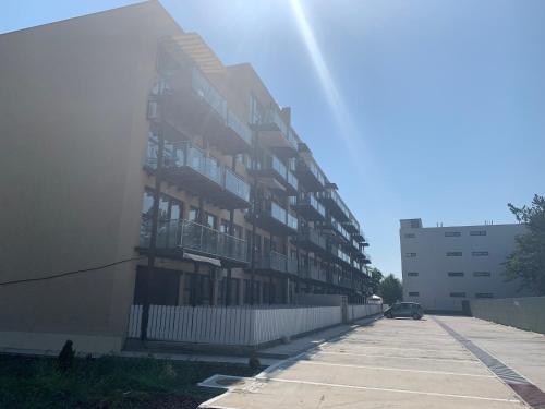 an apartment building with a car parked next to it at Studio Gul Mona Saturn in Saturn