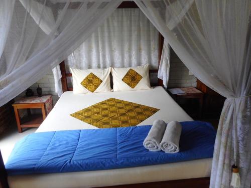 Кровать или кровати в номере Tegal Jero Homestay