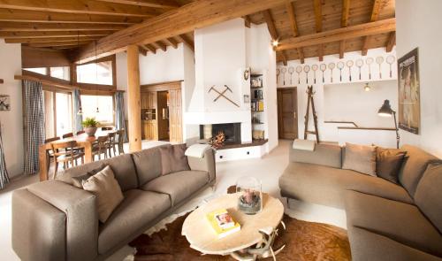 a living room with a couch and a table at Arena Penthouse in Flims
