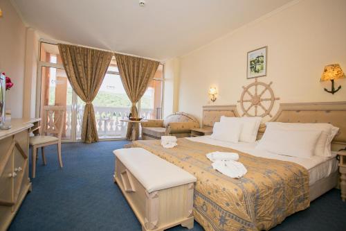 a hotel room with a large bed and a window at Royal Park Hotel - All Inclusive in Elenite