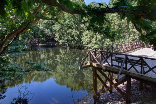 a bench on a bridge over a river at Antartisa B&B in Límni
