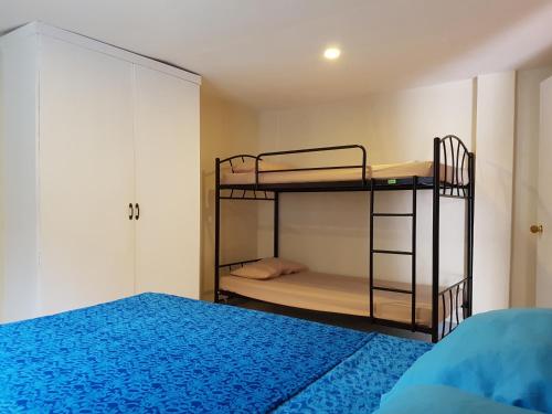 a bedroom with two bunk beds and a bed at OMG Guesthouse Apartment for 6 in Kinalupang