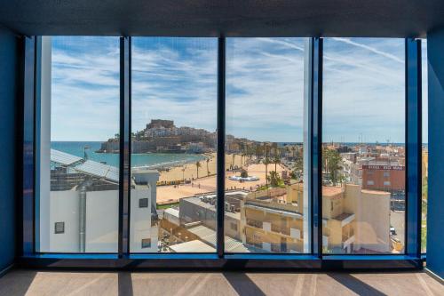 a view of the beach from a window in a building at Hotel Prado II in Peniscola