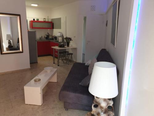 a living room with a couch and a table at רויאל פארק1 in Eilat