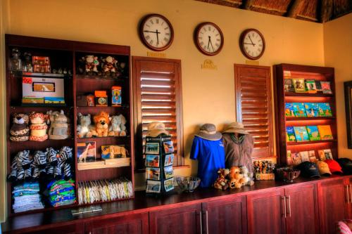 a room with clocks on the wall and a counter with toys at Oceana Beach and Wildlife Reserve in Port Alfred