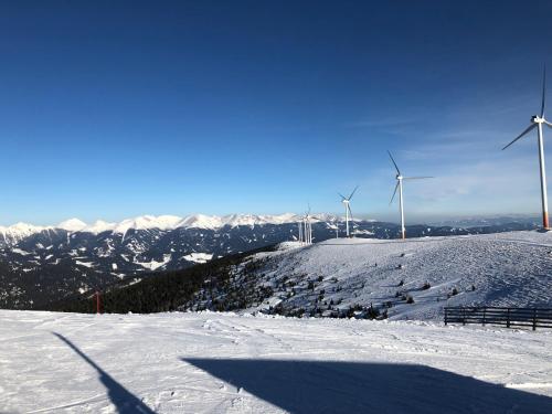 a group of windmills on top of a snow covered hill at Mankerl Hütte Lachtal in Lachtal