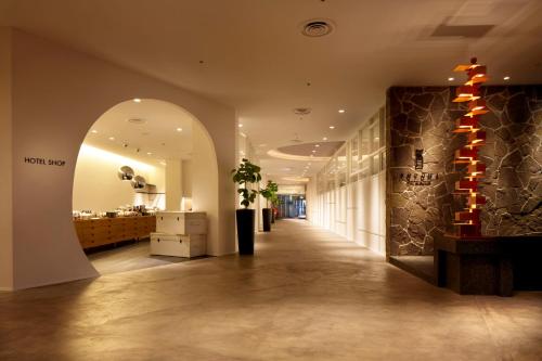 a hallway with an archway in a building at Hilltop Resort Fukuoka in Fukuoka