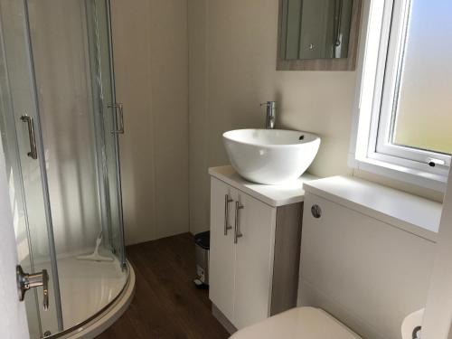 a bathroom with a sink and a shower at Tannisby Camping in Tversted