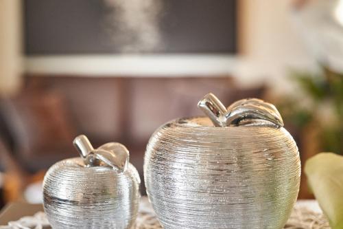 two silver spoons sitting on top of a table at KitzHome City Apartments in Kitzbühel