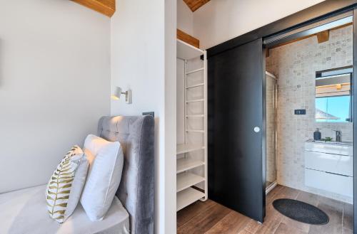 a bathroom with a black closet and a sink at Golden Haven in Murter